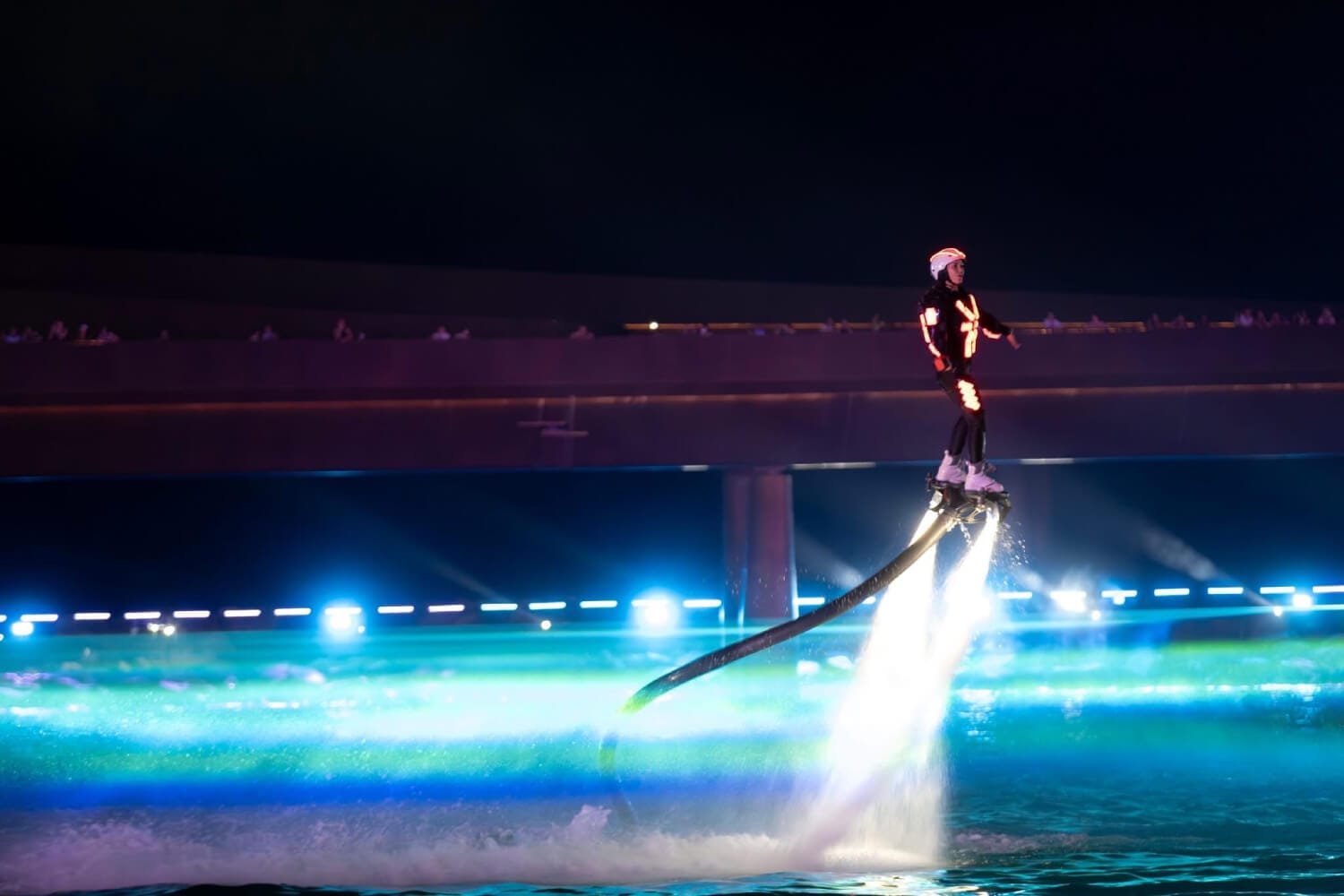 World champion Flyboarders in LED suits doing mid-air acrobatics during the Symphony of the Sea show