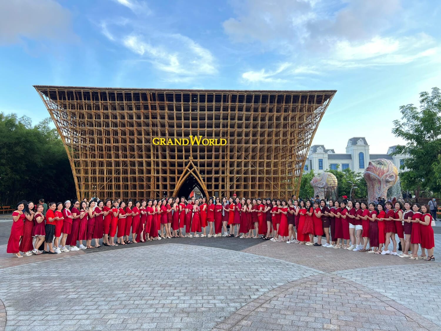 Tourists taking photos at the massive and intricate Bamboo Legend architectural structure at Grand World Phu Quoc during a cool afternoon