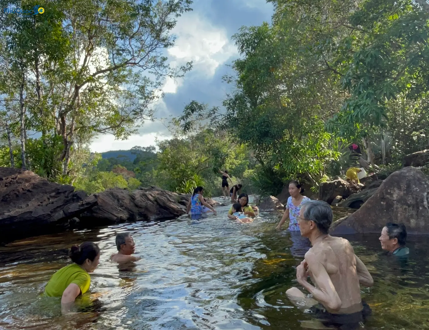 Travelers bathing in clear natural pool at Suoi Tien Phu Quoc