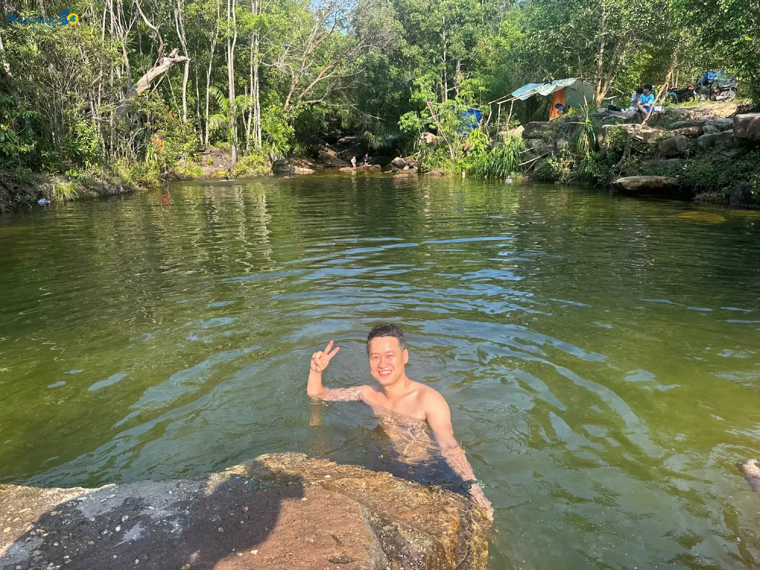 Tourists bathing in a natural pool at Da Ban Stream Phu Quoc