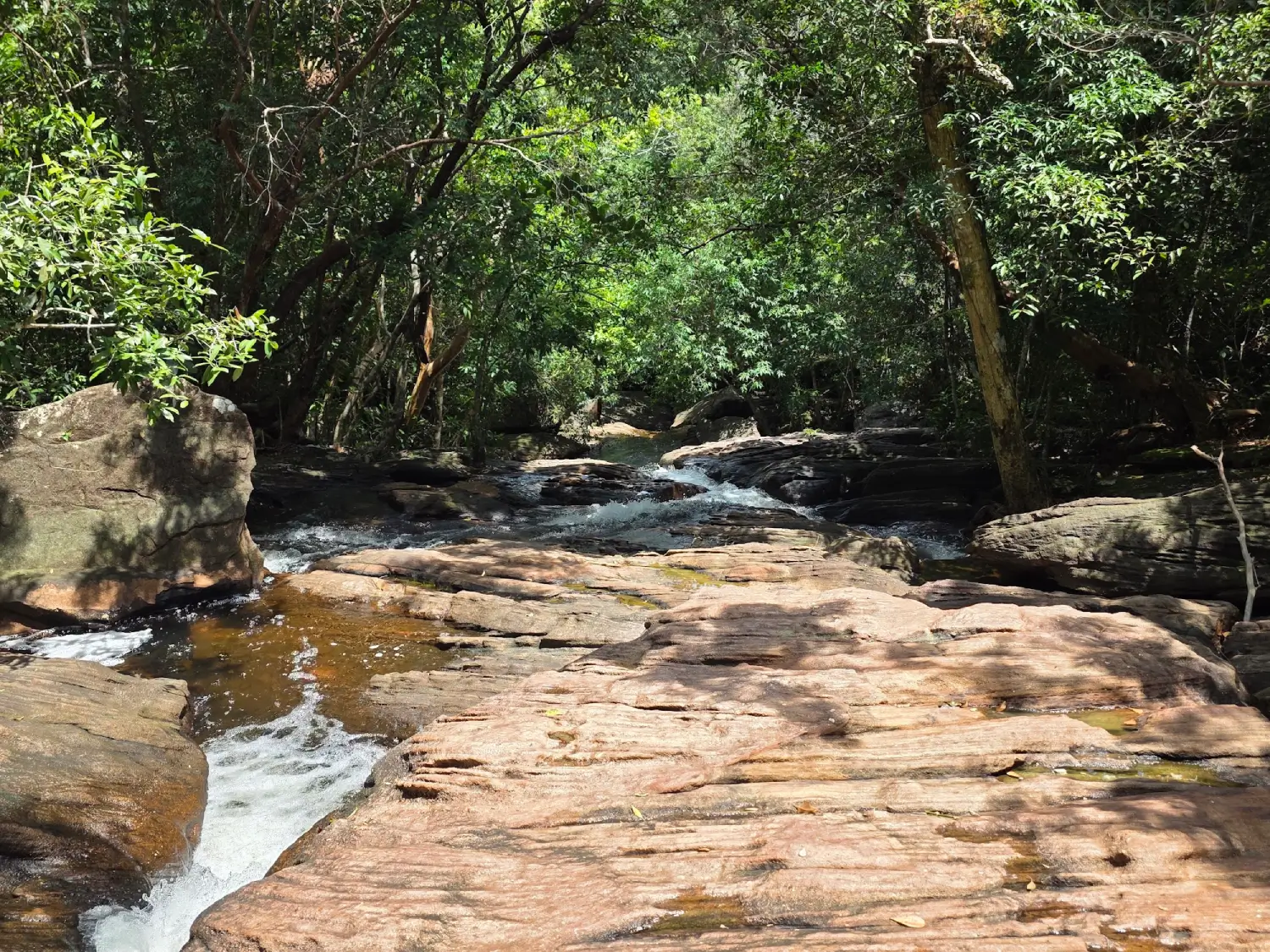 Small waterfall cascading over granite rocks at Suoi Tien Phu Quoc in the rainy season
