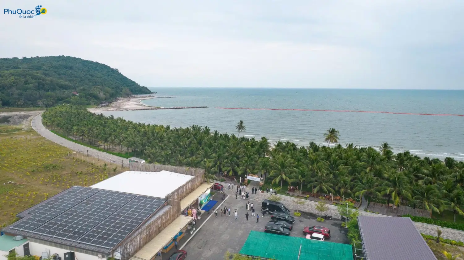 Panoramic view of Vinh Dam Phu Quoc with calm sea and lush green forest surroundings
